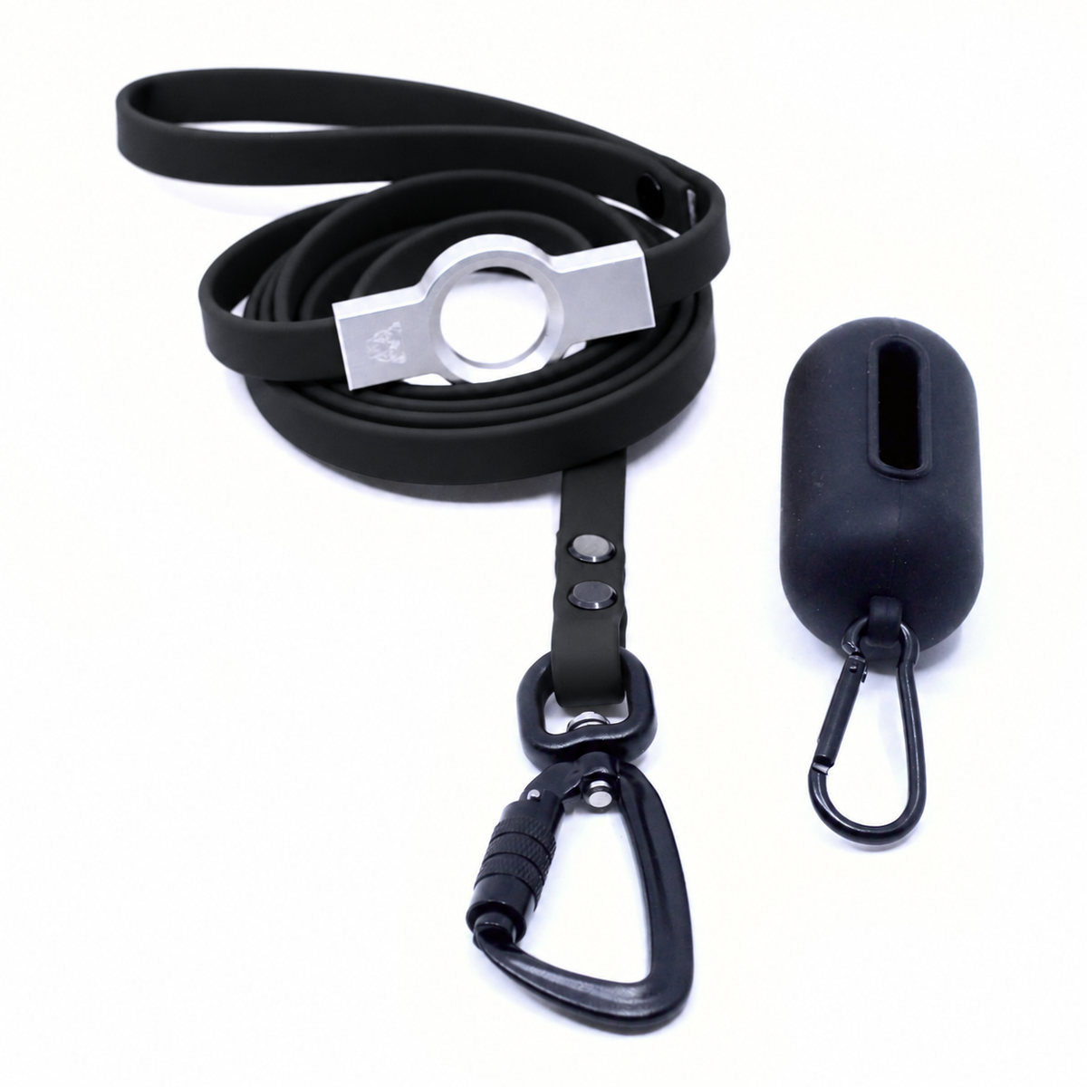 A black silicone dog leash with a silver metal buckle, shown coiled next to a matching black dog poop bag holder with a carabiner clip on a white background.